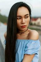 Beautiful portrait of a cute Asian girl with long hair, outdoors photo