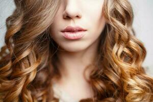 Beautiful pink lips close-up. Girl with curly hair photo