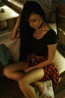 Beautiful stylish hipster girl with long black hair resting in a bar photo