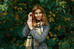 Beautiful young girl on the background of autumn leaves. photo