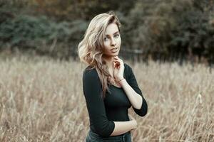 Pretty woman in a black shirt in the corn field photo