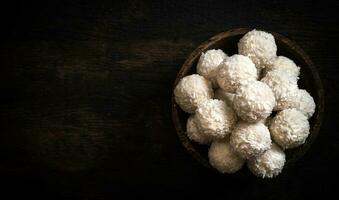 Coconut pralines in bowl photo