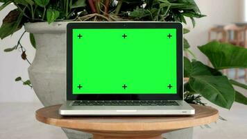 Chroma key green screen laptop computer set up for work on wooden desk on living room, Home interior or office background, mock up, technology concept, zoom in. video