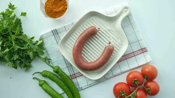 top view of sausage and vegetables on table , video