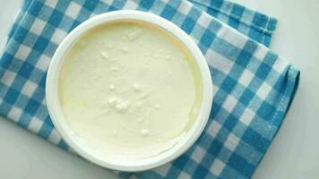 fresh yogurt in a bowl on table . video