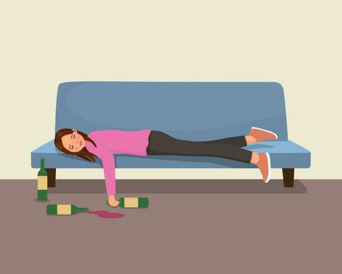 Drunk young woman lying on sofa with alcohol bottles on the floor