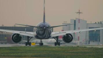 MOSCOW, RUSSIAN FEDERATION JULY 28, 2021 - Boeing 777 of Aeroflot rides on the runway at Sheremetyevo Airport. Airplane turns airport background. Tourism and travel concept video