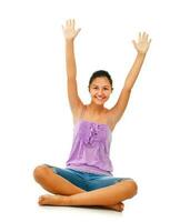 Sitting teenage girl while rejoices with arms up. photo