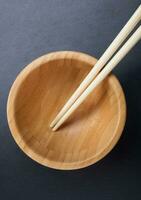 Chopsticks with empty bowl on slate. photo
