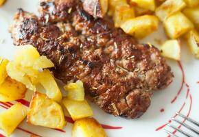 Grilled meat sausages with potatoes photo