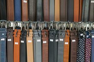 Stack of leather belts for sale photo