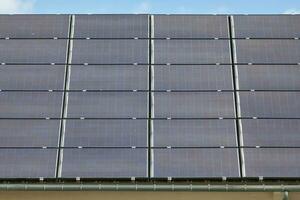 Solar panels covering the roof of a building photo