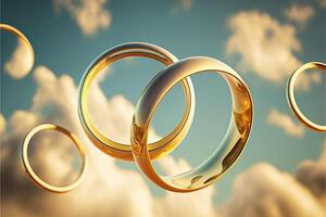 A pair of gold wedding rings floating in the sky. two wedding rings floating in the clouds with a sun in the background and a blue sky with clouds below them. . Wedding concept. photo