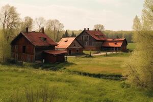 Village barn and abandoned farm houses made of red wood in field. photo