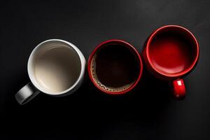 Three coffee mugs white and red top down view. photo