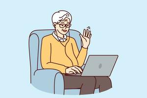 Elderly man makes video call through laptop sitting in chair and waving hand greeting interlocutor. Elderly human with laptop learns computer literacy by participating in online webinar vector