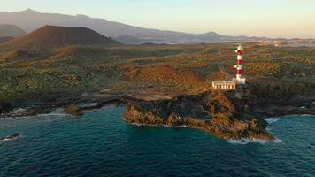 Aerial view of the lighthouse Faro de Rasca, nature reserve and the mountains at sunset on Tenerife, Canary Islands, Spain. Wild Coast of the Atlantic Ocean. video