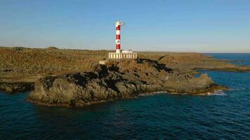 aéreo ver de el faro faraón Delaware rasca, naturaleza reserva y el montañas a puesta de sol en tenerife, canario islas, España. salvaje costa de el atlántico océano. video