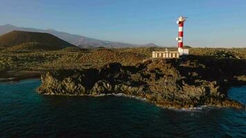 Aerial view of the lighthouse Faro de Rasca, nature reserve and the mountains at sunset on Tenerife, Canary Islands, Spain. Wild Coast of the Atlantic Ocean. video