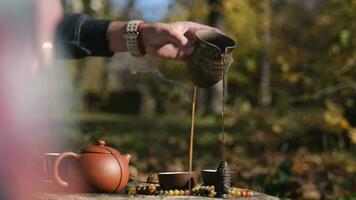 tea master pours tea from a clay pot into a bowl video