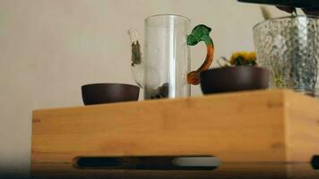 tea master pours hot water into a small glass teapot video