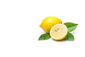 Whole and slice lemon with leaves isolated on white background with copy space. photo