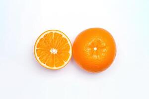 Top view of fresh whole and sliced oranges isolated on white background. photo