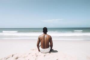 espalda ver de un hombre sentado en un playa. ai generado foto