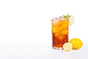 a glass of iced lemon tea with a slice of lemon isolated on white background with copy space. photo