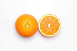 Top view of fresh whole and sliced oranges isolated on white background. photo