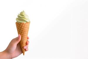 Hand holding delicious matcha ice cream in a crispy waffle cone with copy space. photo