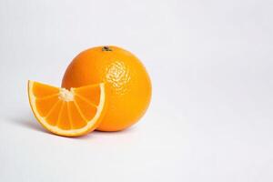 Fresh whole and sliced oranges isolated on white background with copy space. photo