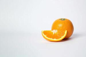 Fresh whole and sliced oranges isolated on white background with copy space. photo