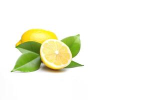 Whole and slice lemon with leaves isolated on white background with copy space. photo