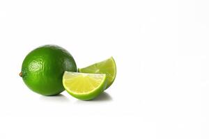 Whole and slice lime isolated on white background with copy space. photo