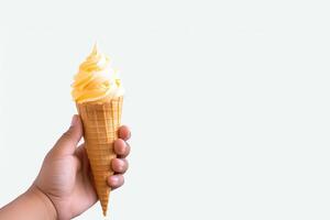 Hand holding delicious mango ice cream in a crispy waffle cone with copy space. photo