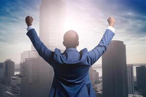 Successful businessman raising hand and expressing positivity while standing against skyscrapers background. photo