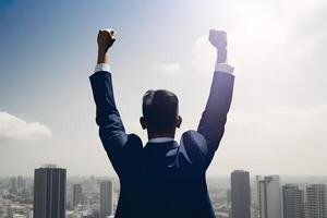 Successful businessman raising hand and expressing positivity while standing against skyscrapers background. photo