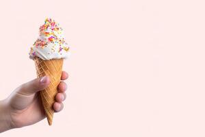 Hand holding delicious sprinkles ice cream in a crispy waffle cone with copy space. photo