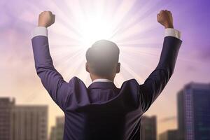 Successful businessman raising hand and expressing positivity while standing against skyscrapers background. photo