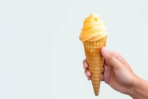 Hand holding delicious mango ice cream in a crispy waffle cone with copy space. photo