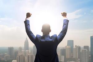 Successful businessman raising hand and expressing positivity while standing against skyscrapers background. photo