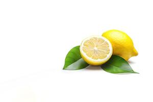 Whole and slice lemon with leaves isolated on white background with copy space. photo