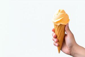 Hand holding delicious mango ice cream in a crispy waffle cone with copy space. photo