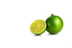 Whole and slice lime isolated on white background with copy space. photo