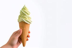Hand holding delicious matcha ice cream in a crispy waffle cone with copy space. photo