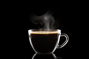 Close up a cup of a black hot coffee with smoke on black background. photo