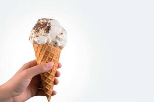 Hand holding delicious cookies and cream ice cream in a crispy waffle cone with copy space. photo