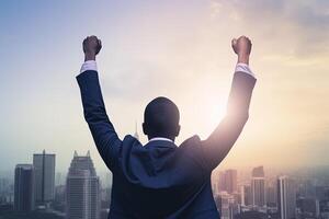 Successful businessman raising hand and expressing positivity while standing against skyscrapers background. photo