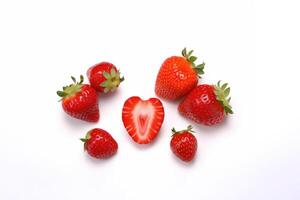 Fresh some whole and sliced strawberries isolated on white background. photo